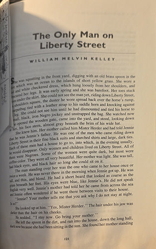 A close-up of an open book page showing the title 'The Only Man on Liberty Street' by William Melvin Kelley, with black serif text on a warm beige paper background. shows the personal note tucked into the pages.