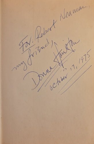 Autographed book page with signature and date on a beige background