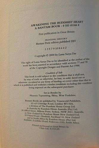 A close-up of a book's printed copyright page, showing black text on an off-white paper background. Visible text includes the title 'Awakening the Buddhist Heart: A Bantam Book' and publisher information for Bantam Press and Random House.
