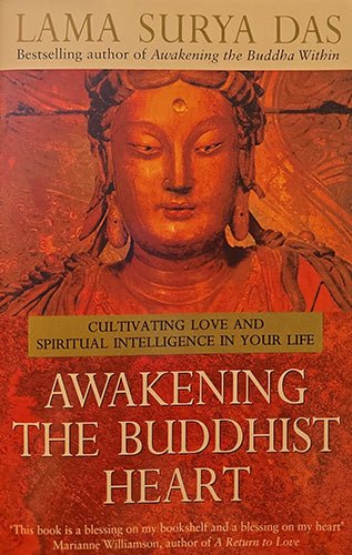 Book cover of 'Awakening the Buddhist Heart' by Lama Surya Das, featuring a warm-toned Buddha statue illustration in red, orange, and brown hues with gold text.