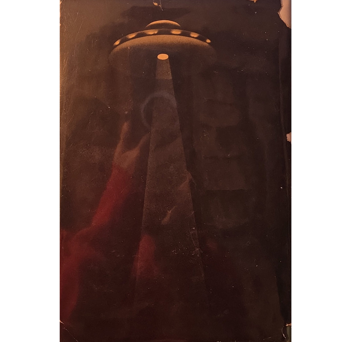 Back cover. A vintage-style sci-fi art print depicting a classic flying saucer UFO casting a beam of light down into a dark, atmospheric landscape with a red glow in the foreground.