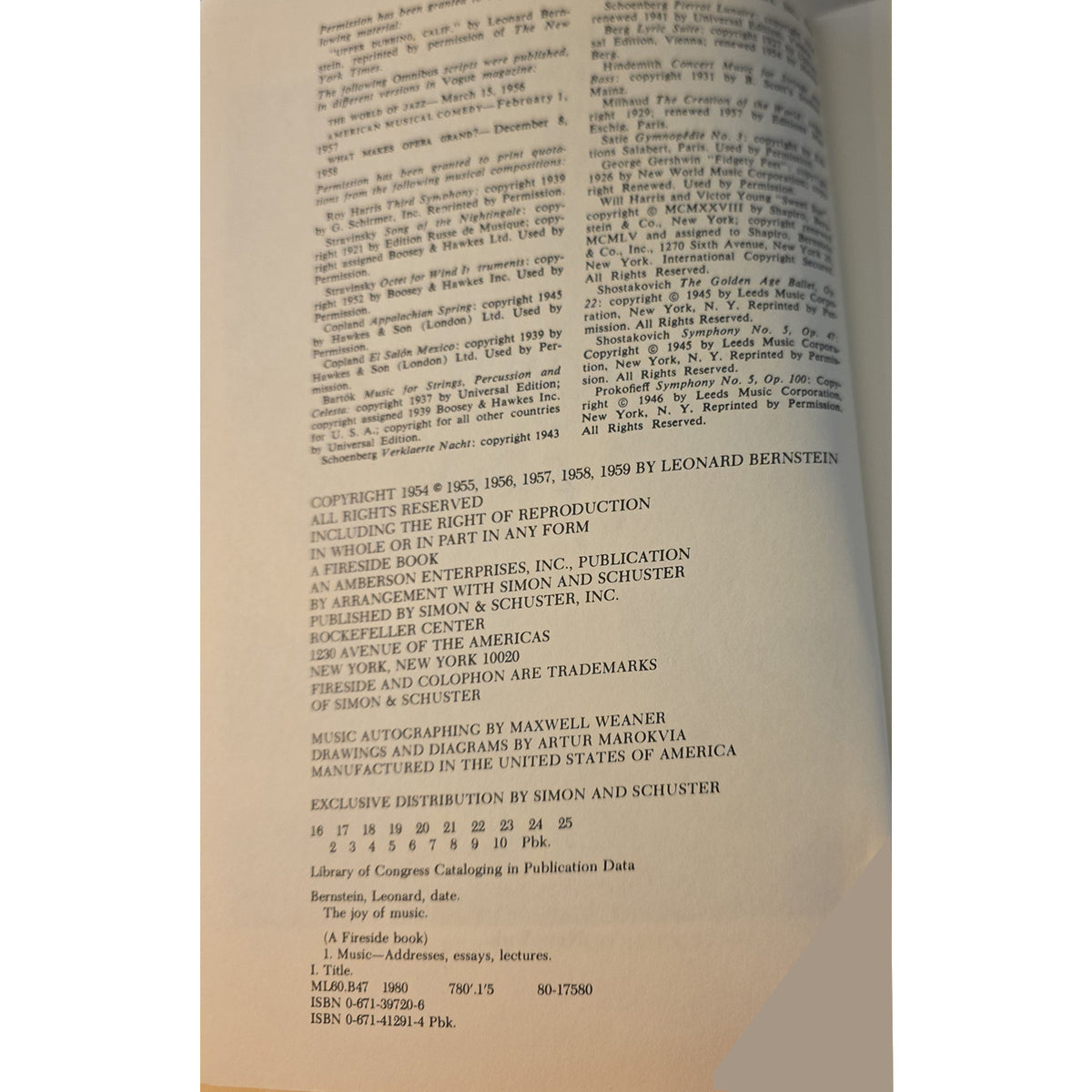 A close-up of an open book's printed page showing copyright and publication details in black text on aged, warm-toned paper.