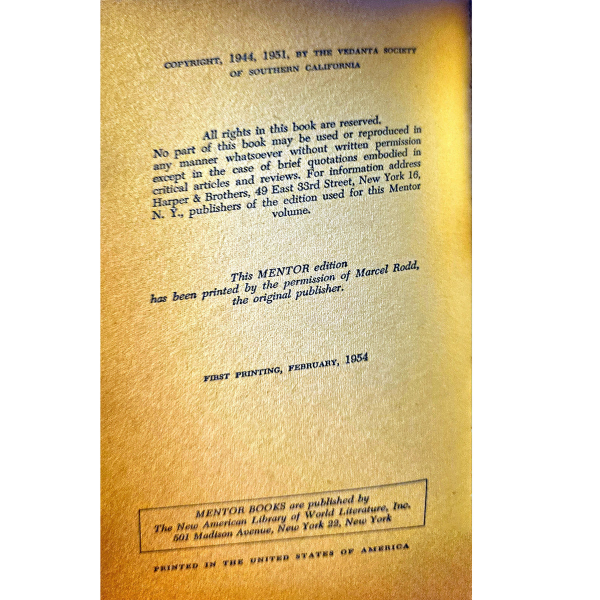 The half title of a vintage Mentor edition book, showing the title page with copyright details printed in black on a textured gold background.