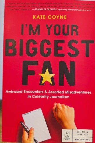 Book cover of 'I'm Your Biggest Fan' by Kate Coyne with a red background and hand holding a notepad.