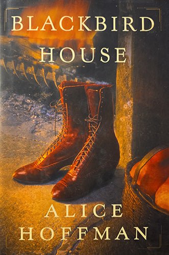 Front dust jacket of Blackbird House by Alice Hoffman, featuring a pair of brown lace-up boots beside a hearth with warm amber tones and the title in large serif lettering.