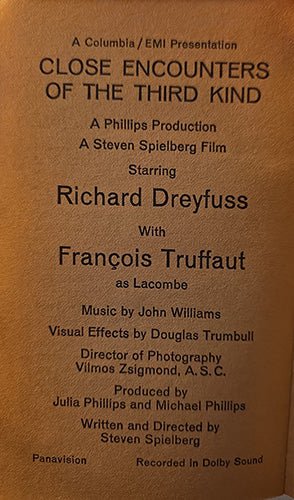 A close-up of a brown paper or cardboard label with black printed text reading 'Close Encounters of the Third Kind' and credits for Richard Dreyfuss and François Truffaut.