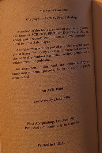 A close-up of a book's copyright page, showing printed text on warm tan paper with a small red publisher mark at the bottom.