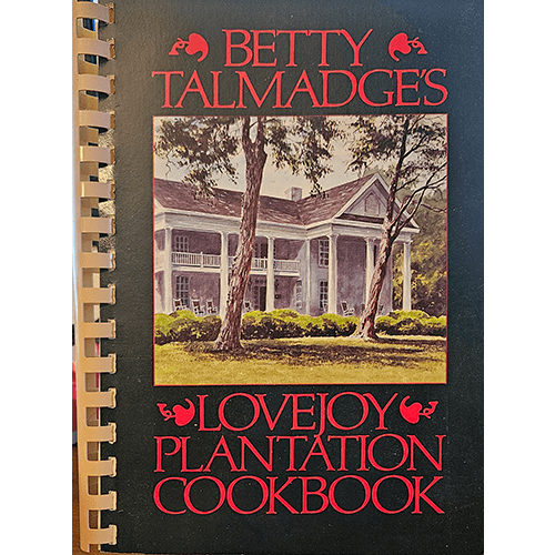 Cover of Betty Talmadge’s Lovejoy Plantation Cookbook, featuring a grand Southern plantation home with red typography on a black spiral-bound book.