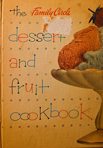 Vintage-style cookbook cover titled "the Family Circle dessert and fruit cookbook" on a warm tan background with dotted pattern, a painted orange dessert cone, and a strawberry illustration.