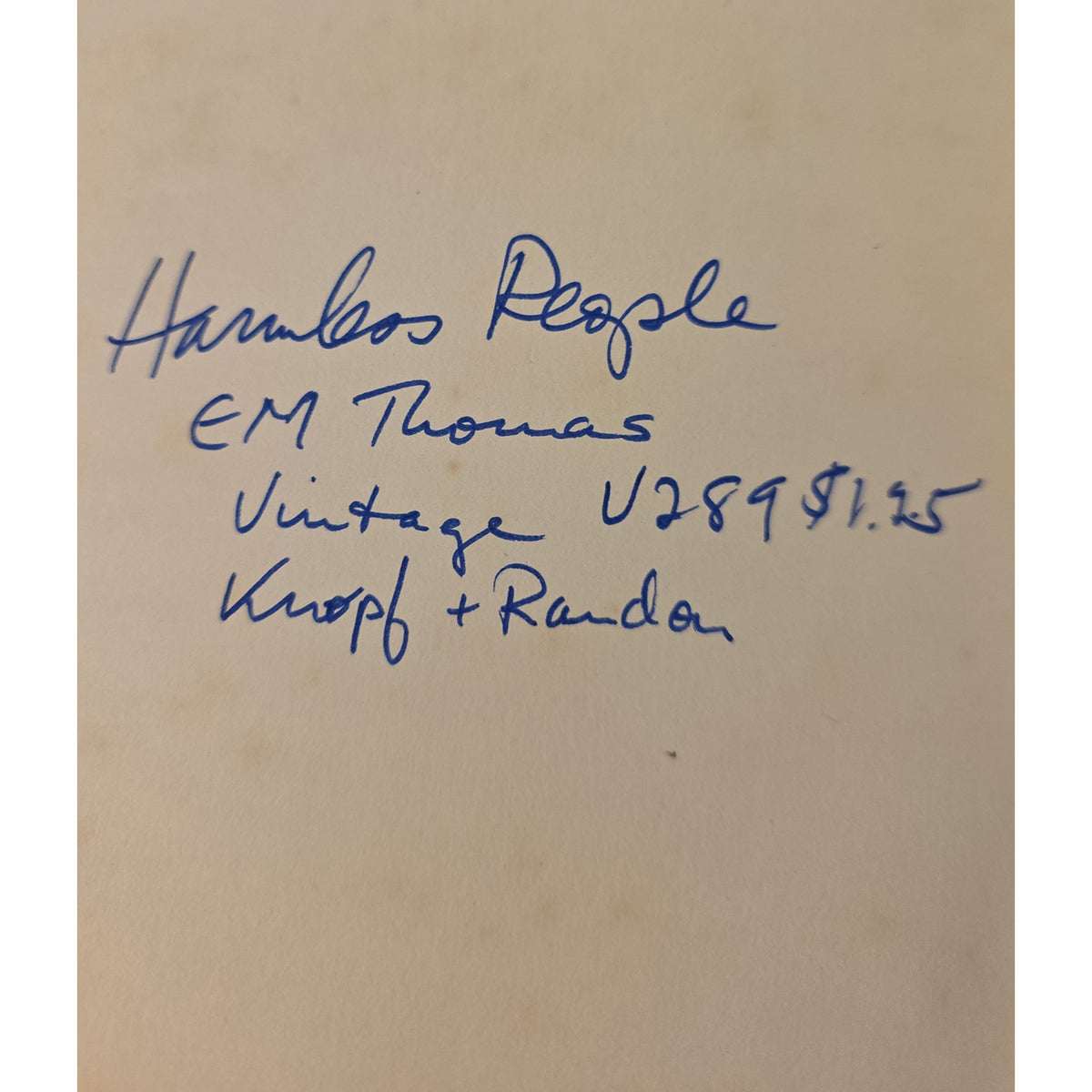 A close-up of handwritten blue ink text on a beige paper background, reading 'Hambos People EM Thomas Vintage U289 $1.25 Kropf + Randa.