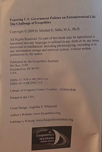 A close-up of a book's publication details, copyright text, ISBN numbers, publisher information, and a logo for the Exopolitics Institute.