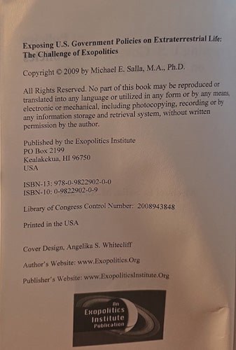 A close-up of a book's publication details, copyright text, ISBN numbers, publisher information, and a logo for the Exopolitics Institute.