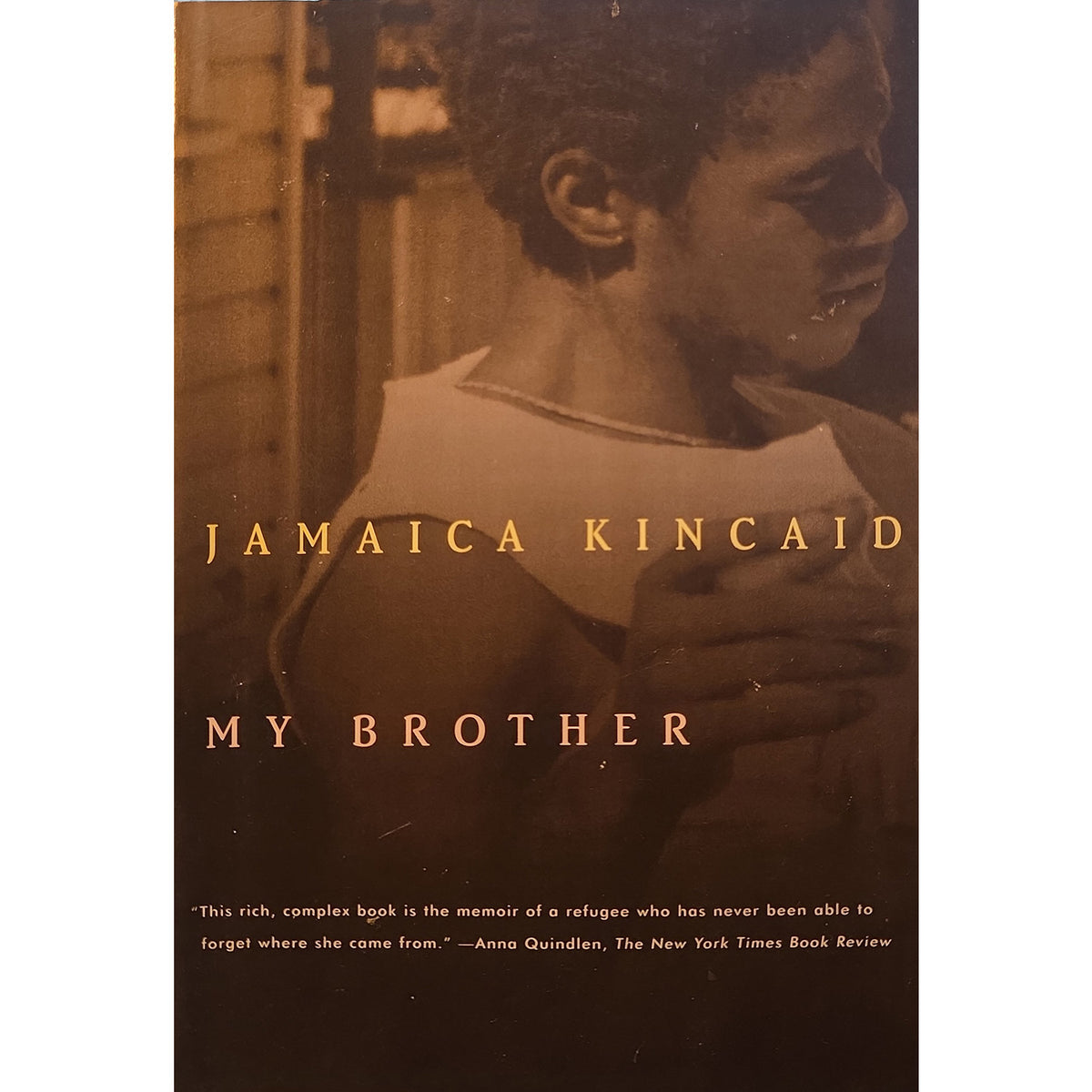 Book cover for 'My Brother' by Jamaica Kincaid, featuring a sepia-toned photograph of a young man in profile with the title text in gold lettering.