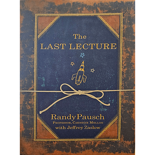 The cover of The Last Lecture features a deep blue background with gold lettering, an illustrated rocket, and a nostalgic ribbon, evoking a timeless message.