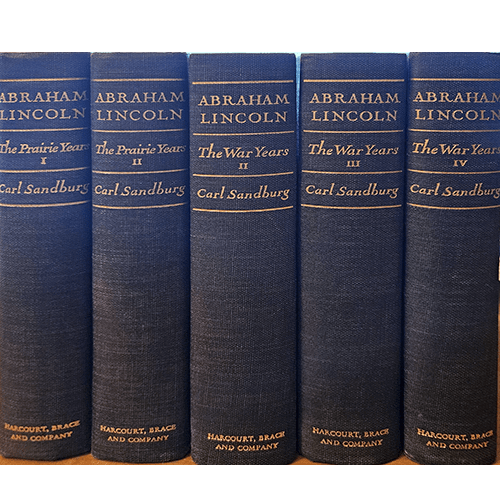The five-volume set of Abraham Lincoln by Carl Sandburg, bound in vintage blue cloth covers, with gold-stamped titles, documenting Lincoln’s life in vivid detail.