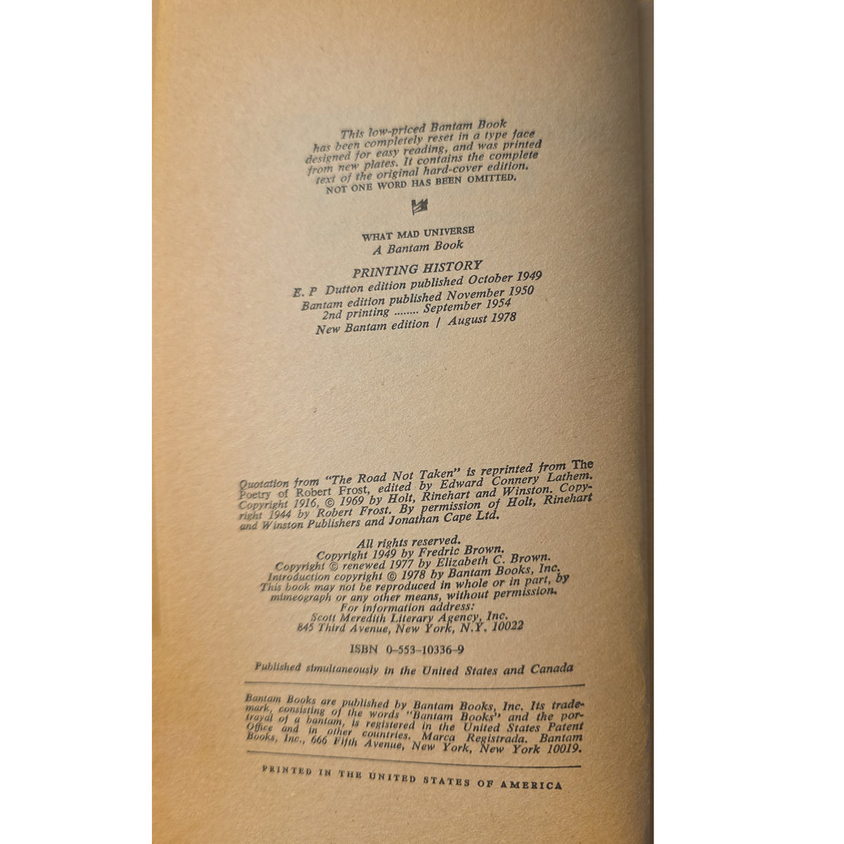 A close-up of the interior printed page of a book, showing publication details and text on warm beige paper.