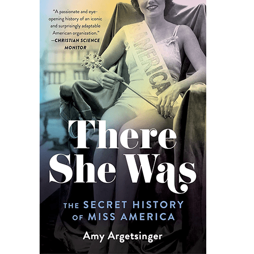 The book cover for "There She Was: The Secret History of Miss America" by Amy Argetsinger features a historical black-and-white photograph of a Miss America pageant winner seated and holding a scepter. She is wearing a sash that reads "America." The title "There She Was" is prominently displayed in bold, white lettering across the lower part of the image. Below the title, the subtitle "The Secret History of Miss America" is written in a smaller blue font.