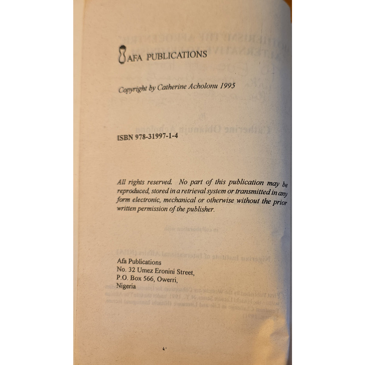 A close-up of a book's copyright page from AFA Publications, showing the title 'African Women Writers' by Catherine Acholoma 1995, with ISBN 978-31997-1-4 and publisher details in Nigeria.