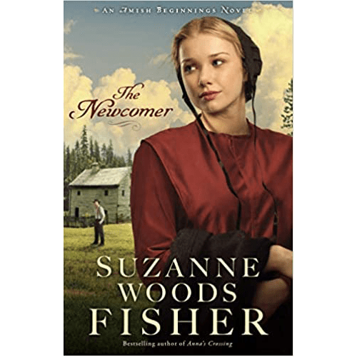 Cover of The Newcomer by Suzanne Woods Fisher shows a young Amish woman in red with a bonnet, standing in a peaceful countryside setting.