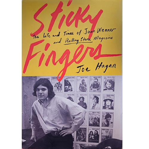 Cover of Sticky Fingers by Joe Hagan, featuring a young Jann Wenner in front of rock star photos. Bold red title on yellow background.
