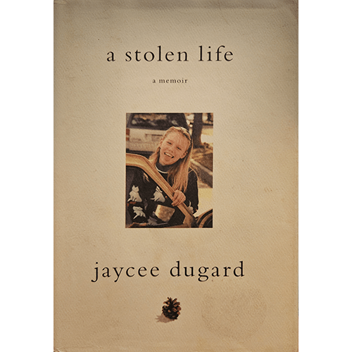 The cover of A Stolen Life: A Memoir by Jaycee Dugard features a young Jaycee smiling while seated in a car, against a cream background with a small pinecone at the bottom, symbolizing nature and hope.