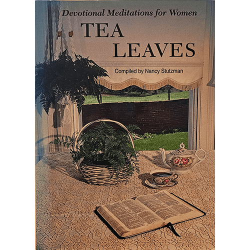 Cover of Tea Leaves: Devotional Meditations for Women shows an open Bible, tea set, and plants on a cozy table by a window, evoking peace and warmth.
