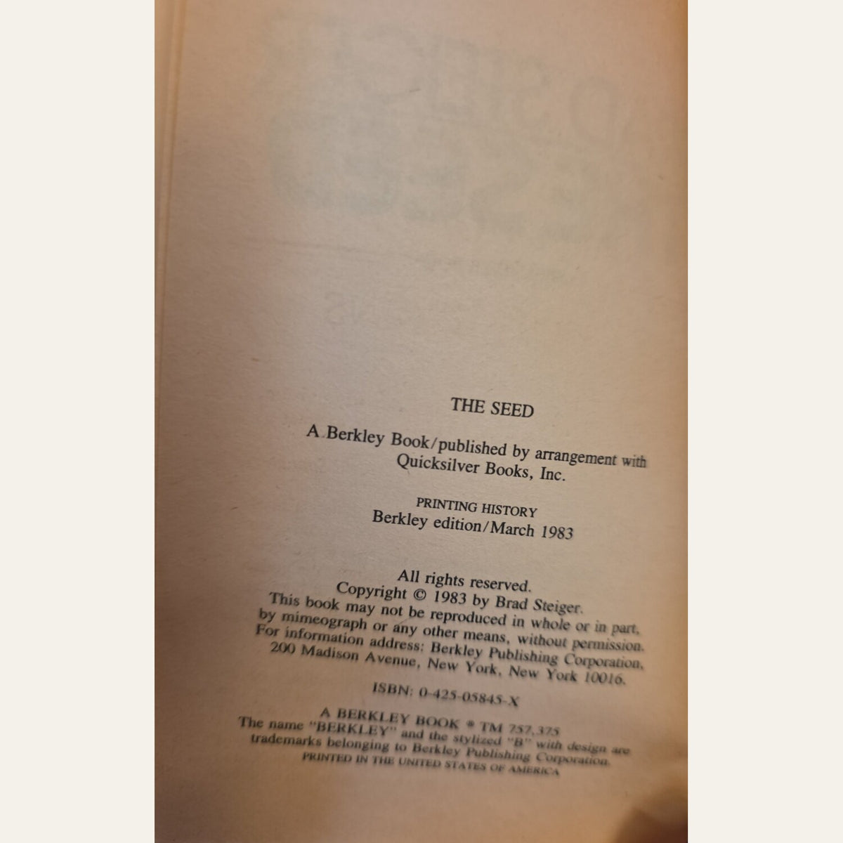 A close-up of a book's printed interior page showing the title 'THE SEED' and publication details for Berkley edition, March 1983, on warm beige paper.
