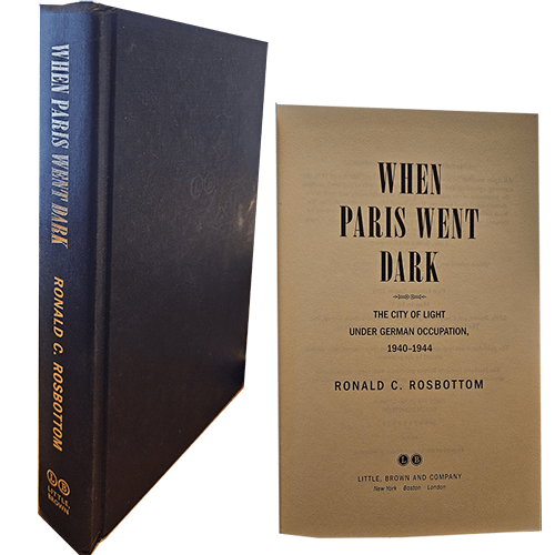Shows the blue cloth cover of When Paris went dark with gold lettering and an interior page.