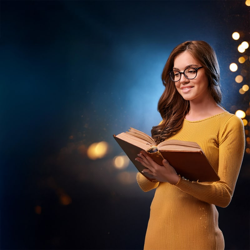 "Young woman reading a classic book with a warm, glowing background, symbolizing the joy of literature."