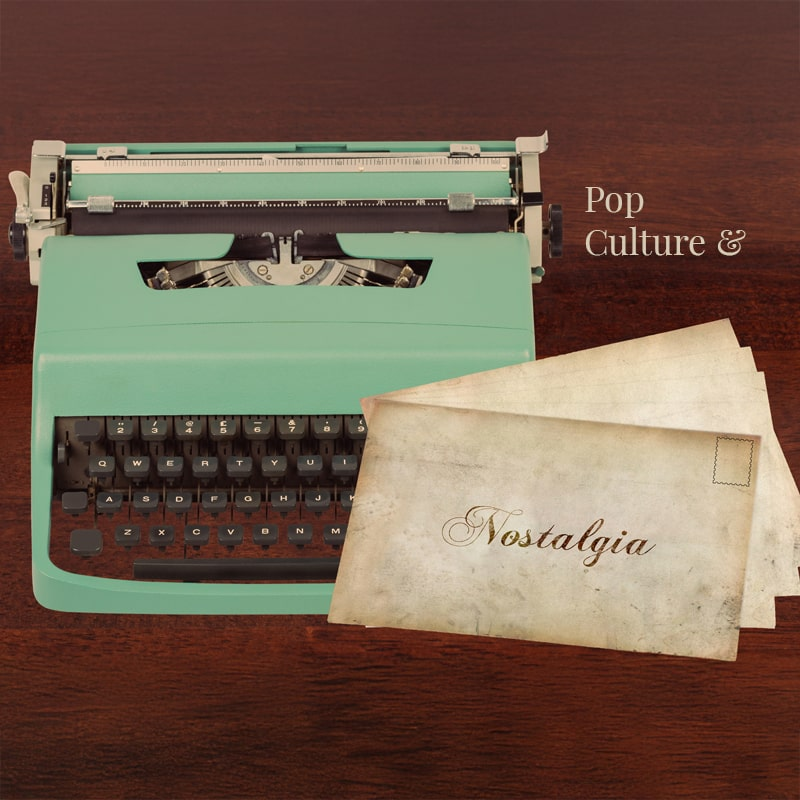 A vintage turquoise typewriter sits on a dark wooden surface alongside aged envelopes, one labeled "Nostalgia" in elegant script. The words "Pop Culture &" appear in the background, evoking a retro aesthetic.