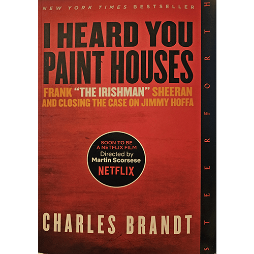 The bold red cover of I Heard You Paint Houses by Charles Brandt features the title in black, with a circle announcing its Netflix adaptation by Martin Scorsese. A gripping true crime story awaits inside.