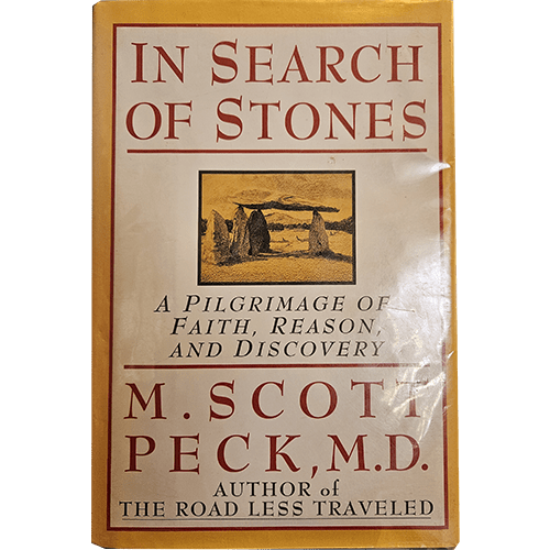  The book cover titled "In Search of Stones" by M. Scott Peck, M.D., features a beige background with red text. A small illustration of standing stones is centered. The subtitle reads, "A Pilgrimage of Faith, Reason, and Discovery." At the bottom, it notes the author of "The Road Less Traveled."