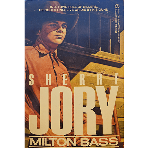 The cover of "Shrrf Jory" by Milton Bass features a stern cowboy, likely Shrrf Jory, standing with a determined expression, dressed in traditional Western attire, against a rugged, wooden backdrop.