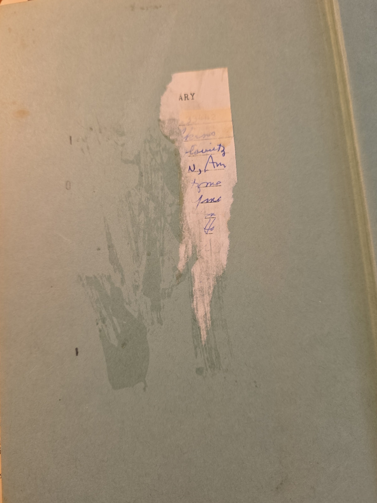 Endpaper of Princess Merle showing remnants of a library card and marks from its removal.