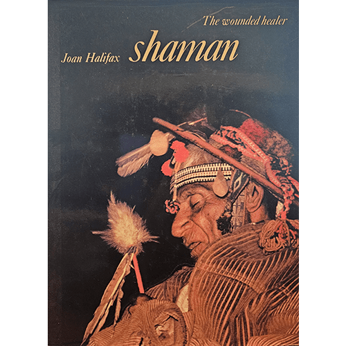 Cover image of "Shaman: The Wounded Healer" by Joan Halifax, featuring a traditional shaman in ceremonial attire, holding a ritual object, set against a dark background, symbolizing mysticism and spiritual healing.