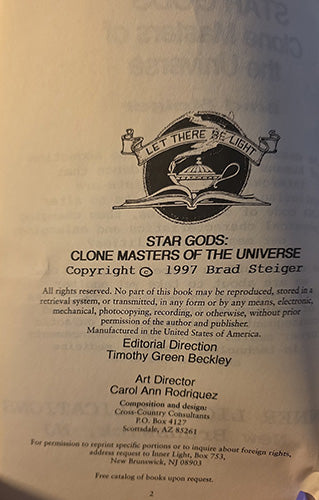 A close-up of a book's printed title page showing the title 'Star Gods: Clone Masters of the Universe' with copyright 1997 by Brad Steiger, plus publisher and production credits, photographed against an off-white page.