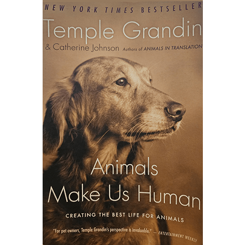 Cover of "Animals Make Us Human" by Temple Grandin featuring a golden retriever gazing thoughtfully. The title and authors' names are in a warm, inviting font with a beige background.