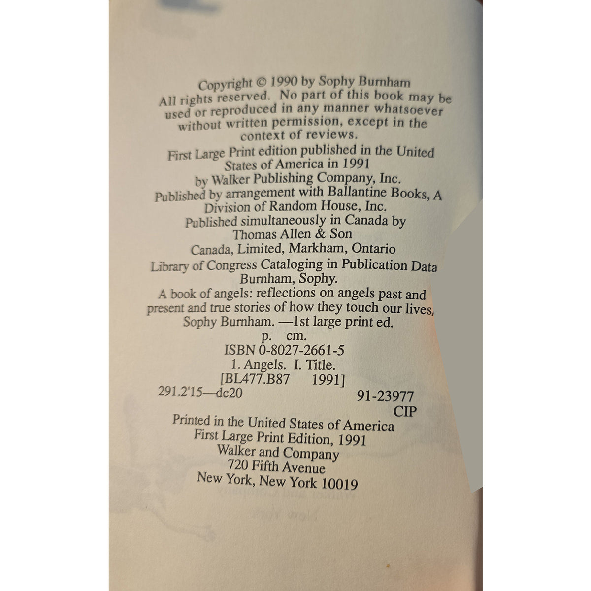 A photographed book page showing copyright and publication details for 'Angels: reflections on angels past and present' by Sophy Burnham, with publisher text for Walker and Company at the bottom.