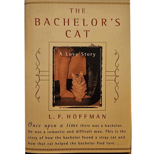 The image is of a book cover titled "The Bachelor's Cat: A Love Story" by L.F. Hoffman. The cover has a beige background with an ornate border. The title is written in red at the top, and below it is an image of a cat standing next to a person's bare feet. The subtitle "A Love Story" is overlaid on the image. At the bottom of the cover, there is a brief synopsis that reads, "Once upon a time there was a bachelor. He was a romantic and difficult man. 