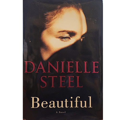 The cover of Beautiful by Danielle Steel features a striking close-up of a woman's face, partially shadowed, with piercing green eyes. The dark background adds to the mystery and depth of the novel's theme.