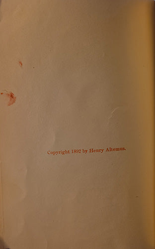 A close-up of a vintage book or manuscript page with a warm beige tone, featuring the printed text 'Copyright 1892 by Henry Alternus.' in red near the lower center.