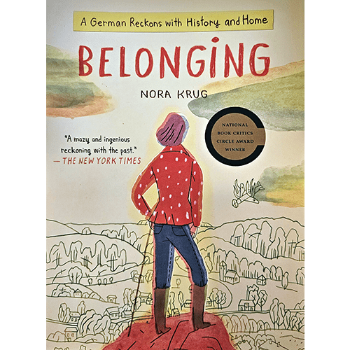 Cover of Belonging: A German Reckons with History and Home by Nora Krug. A woman stands atop a hill, overlooking a landscape, symbolizing a journey through heritage and Germany’s complex past.