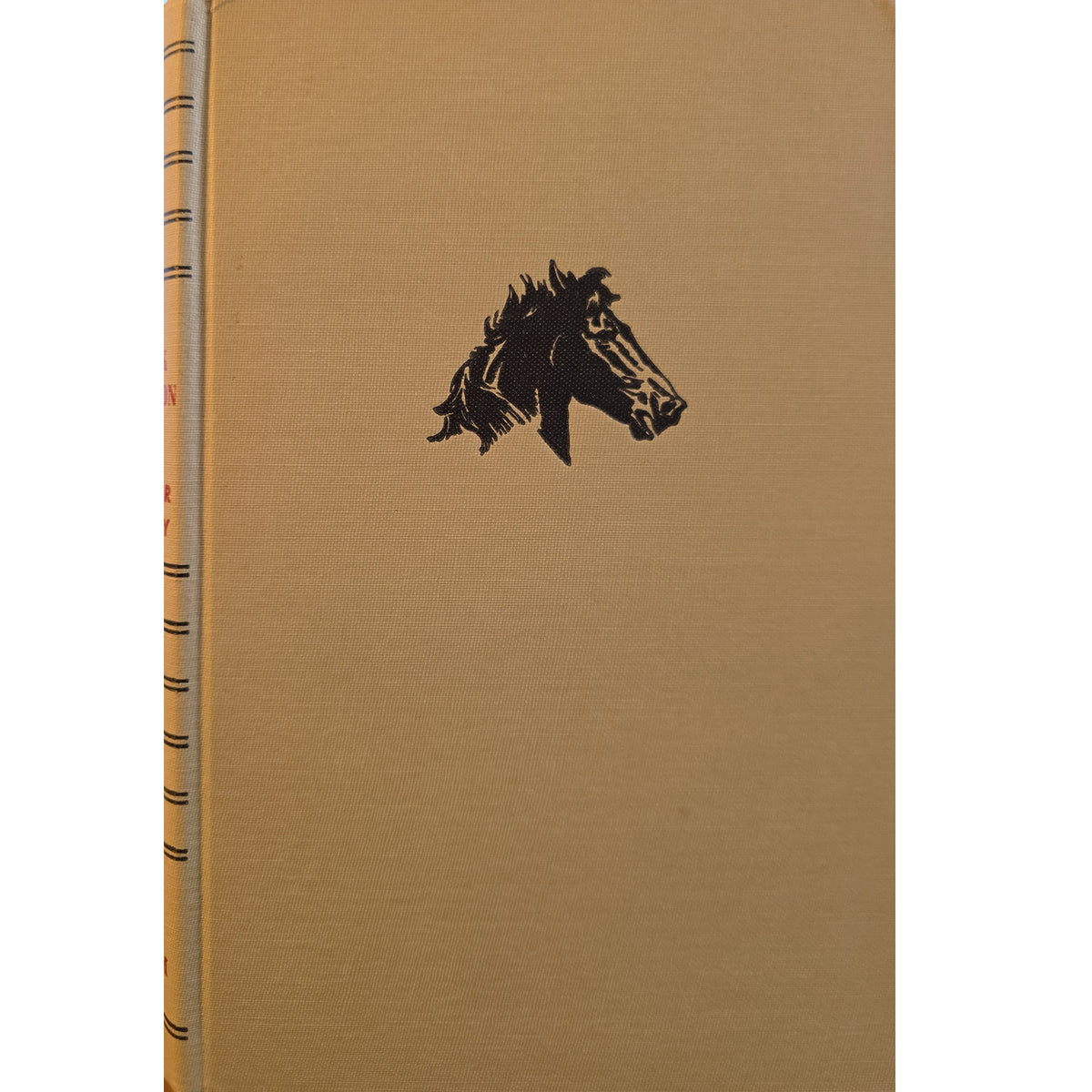 A vintage hardcover book with a tan cloth-bound cover featuring a black horse head illustration, shown against a plain white background.