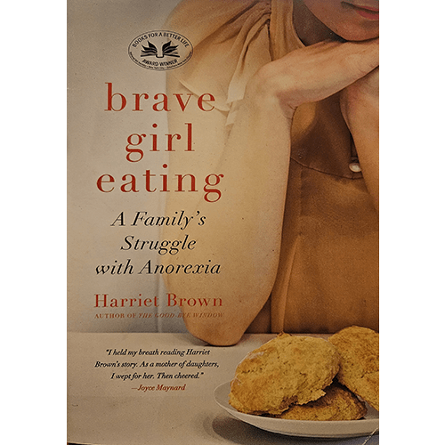 The cover of Brave Girl Eating features a seated girl in a light brown shirt, her hands clasped in thought. Below, golden biscuits sit on a plate, reflecting themes of food and family in the story.