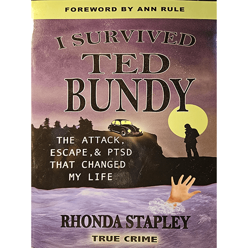 The cover of I Survived Ted Bundy by Rhonda Stapley shows a haunting night scene with a car parked by a cliff, a raised hand emerging from water, and a large full moon illuminating the title. Foreword by Ann Rule.