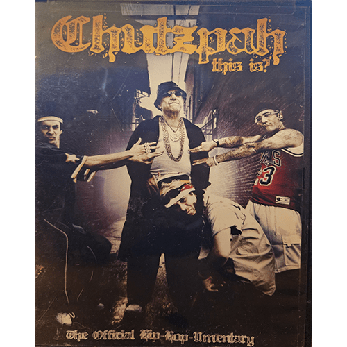 Cover of Chutzpah This Is: The Official Hip-Hop-Umentary, showing four men in hip-hop attire, with the central figure wearing chains and a T-shirt. They stand in an alley, embracing the theme of Jewish hip-hop.