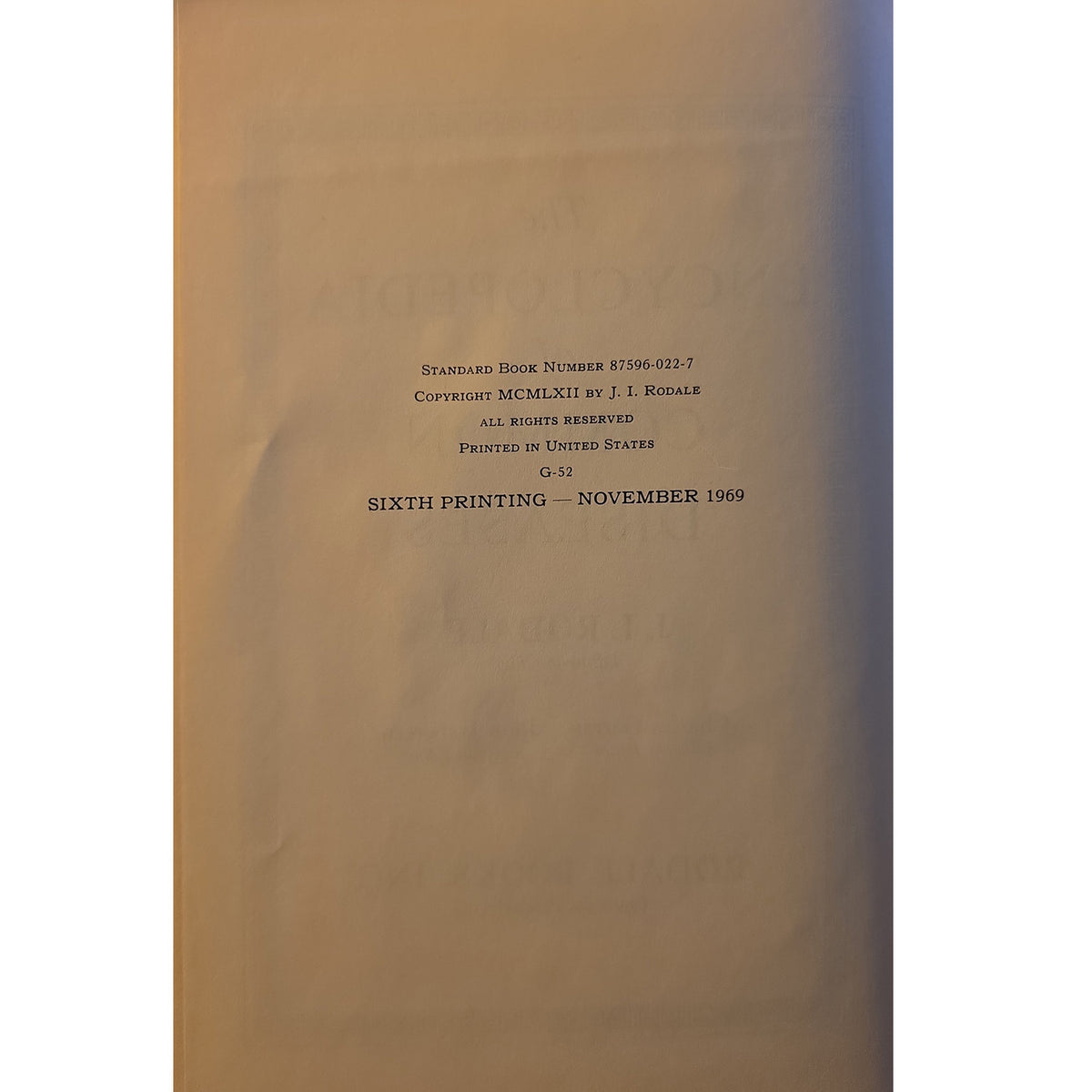 A close-up of a book's title page showing printed text in black on a warm beige paper background.