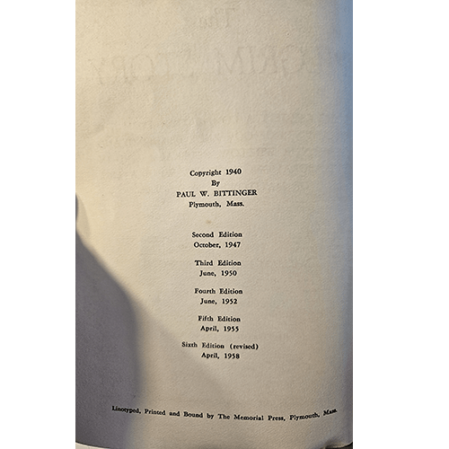 Book spine with publication history text on a green background