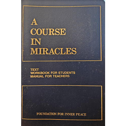 The cover of A Course in Miracles features a dark blue design with gold text, including the title, subtitle, and "Foundation for Inner Peace." Clean and simple, it embodies the book's serene essence.