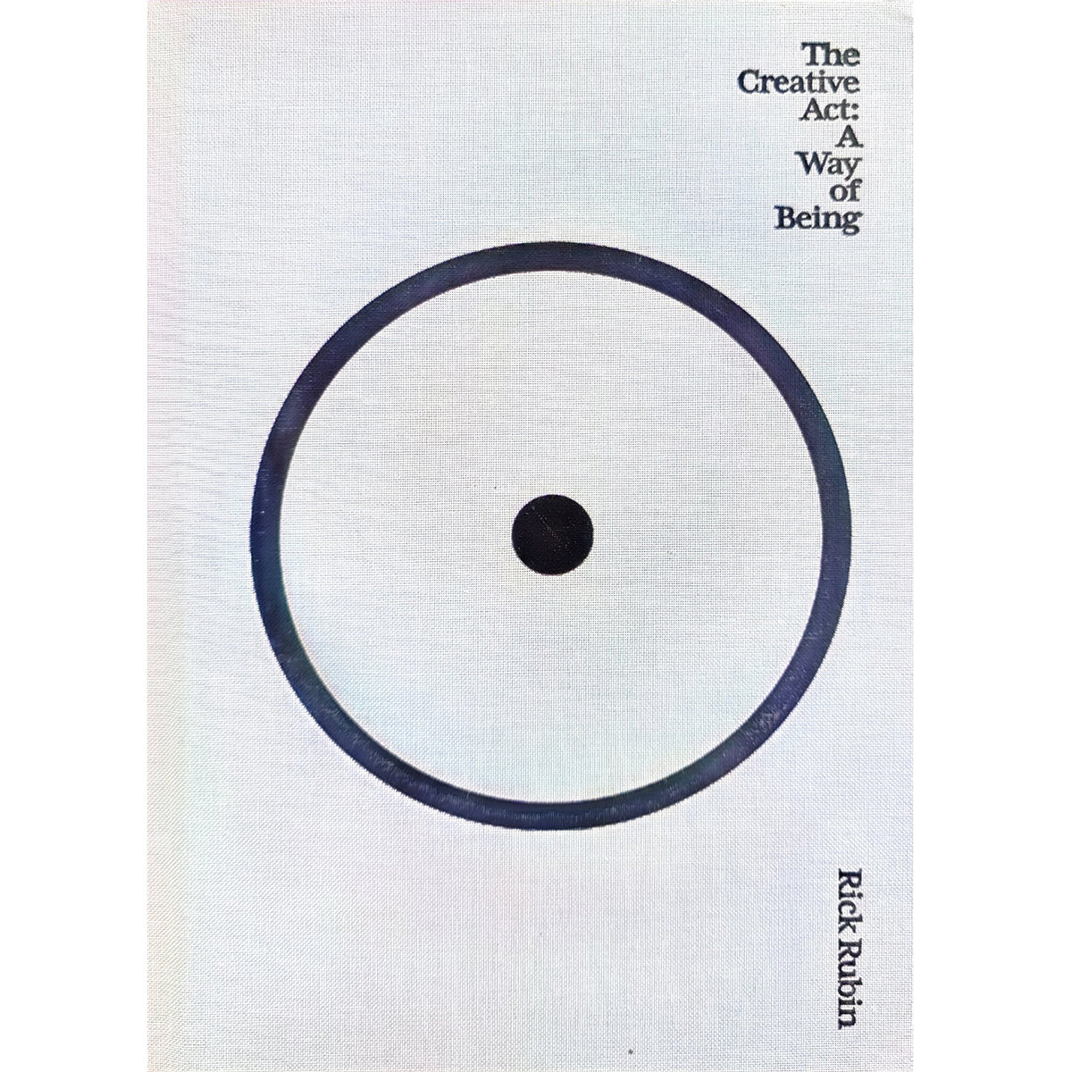 Light cloth hardcover of The Creative Act: A Way of Being by Rick Rubin, featuring a large dark circle with a central dot.
